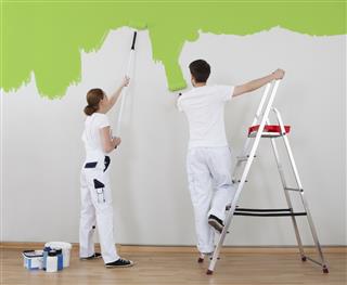 Young Couple Painting Wall