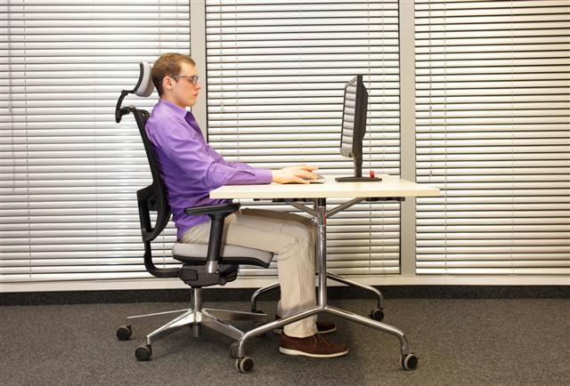 Correct sitting position at workstation with computer