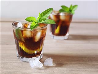 Cocktail with cola and limes slices
