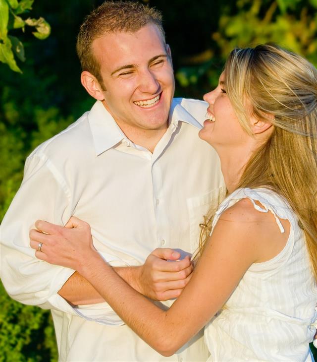 Couple laughing in park