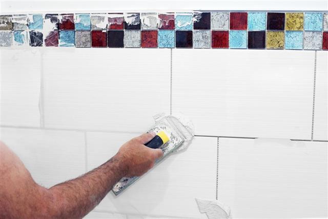 Grouting tiles