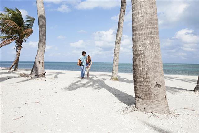 Young couple walking on beach