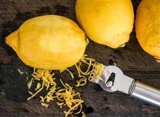 Peeling lemon rind to add zest