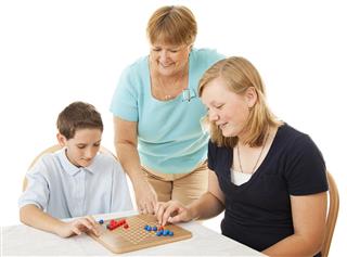 Family playing chinese checkers board game
