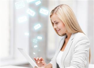 Happy woman with tablet pc and email letters