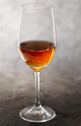Glass of amontillado sherry on wooden plank