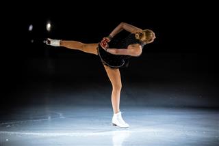 Young female figure skater performing