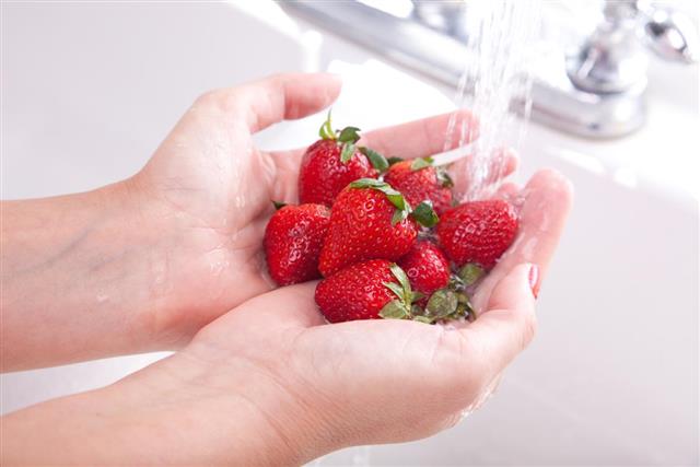 Woman Washing Strawberries
