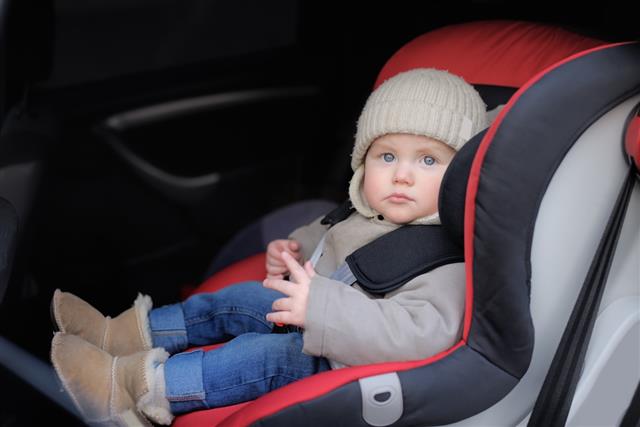 Toddler sitting in car seat
