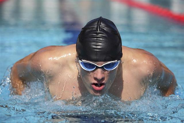 Close up of swimmer Man swimming butterfly strokes