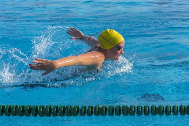 Young woman at butterfly stroke