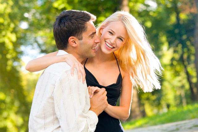 Young happy smiling attractive couple walking outdoors together
