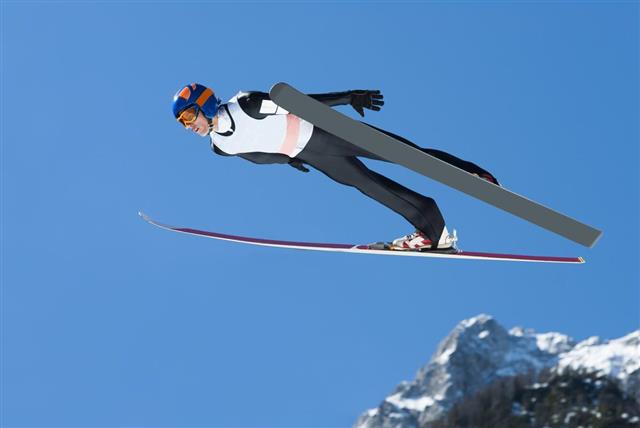 Ski Jumper in Action Against the Blue Sky