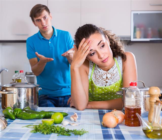 Upset man and frustrated woman at kitchen