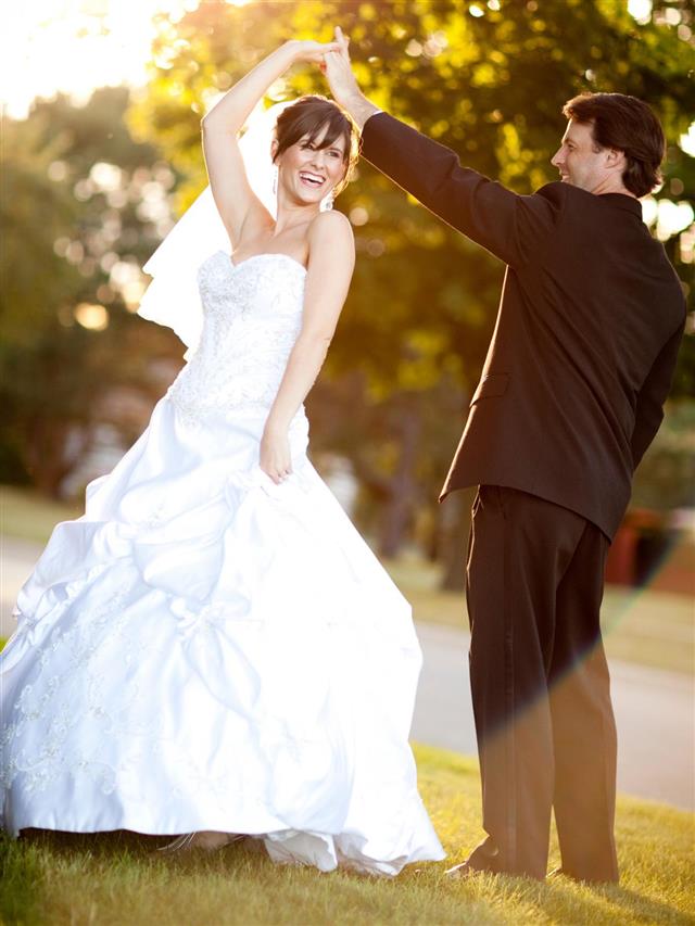 Bride and Groom Twirling and Dancing Together Outside