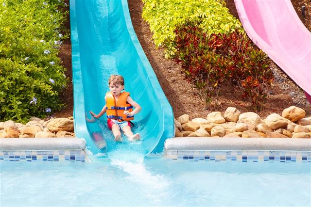 child riding on slide