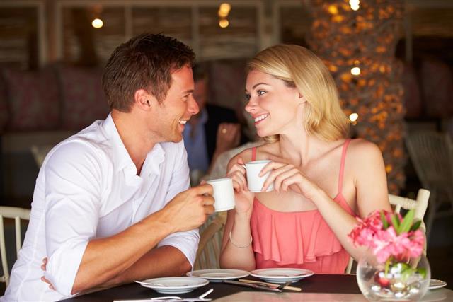Couple Enjoying Cup Of Coffee In Restaurant