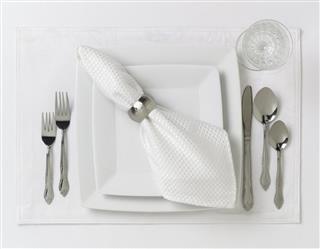 Formal table place setting on white
