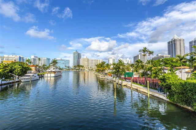 luxury houses at the canal in Miami Beach with boats