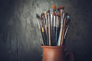 Paintbrushes in a jug from potters clay