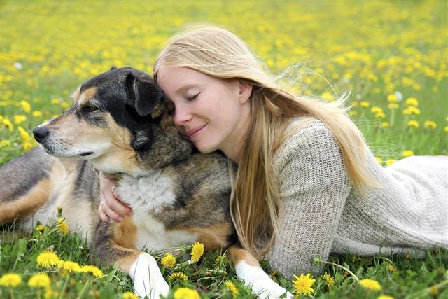Woman Tenderly Hugging German Shepherd Dog