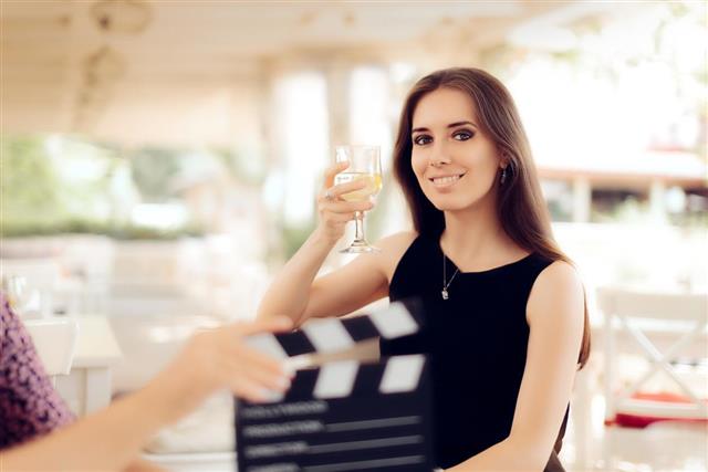 Happy Actress Holding a Glass