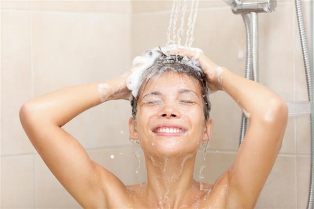 Woman in shower washing hair