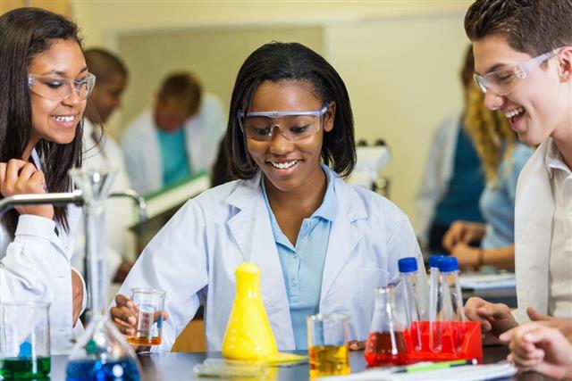 Diverse group of high school students experimenting with chemistry in class