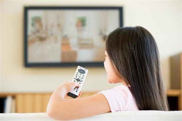 Young girl in living room with television