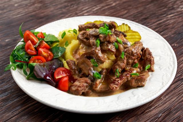 Beef Stroganoff with mashed potatoes and some vegetables