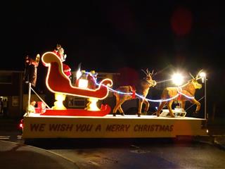 Image of Christmas carnival float with Santa Claus and reindeer
