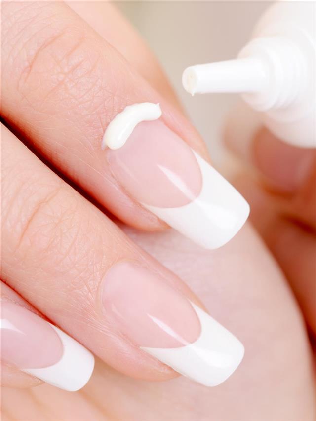 Applying cream on nails