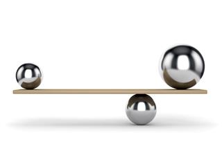 Metal balls balanced on plank