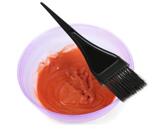 Bowl with dye and brush for hair coloring