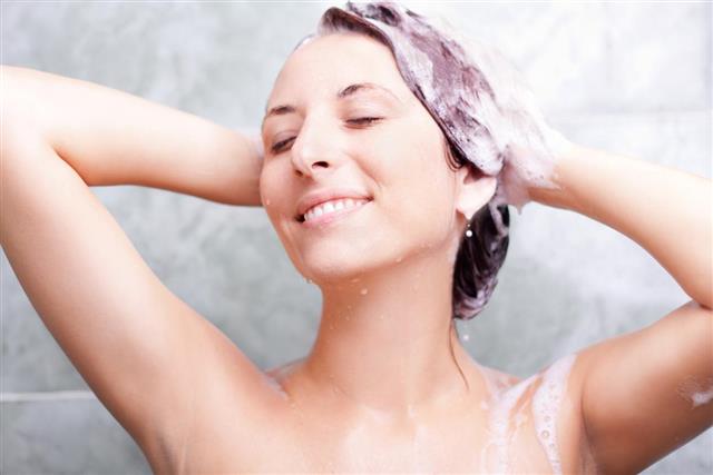 Woman in shower washing hair