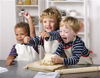 Group Of Happy Toddlers Enjoying Home Baking.