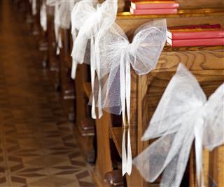 White bows attached to the benches
