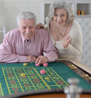 Senior couple with casino chips