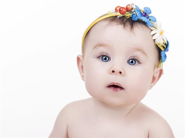 portrait of cute baby with headband with a flowers