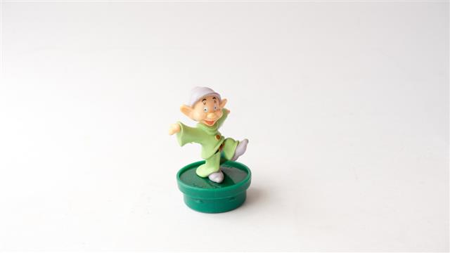 Studio shot of Dopey Dwarf plastic figurine of seven dwarfs