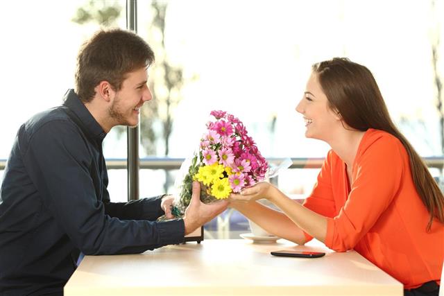 Couple date with man giving flowers