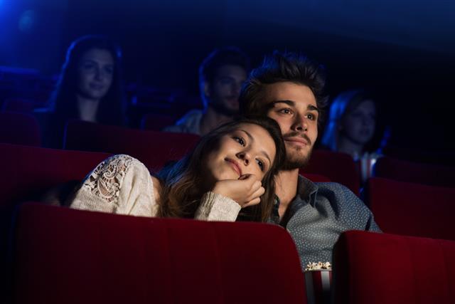 Young loving couple at the cinema