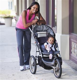 mother pushing baby stroller