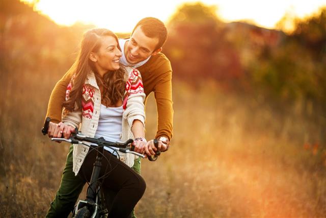 Loving couple driving a bicycle