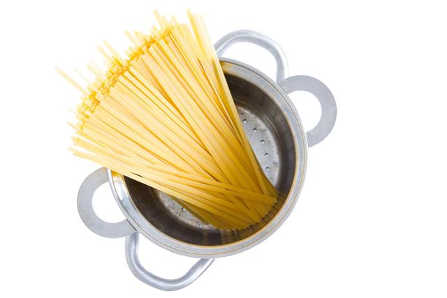 Bundle of dried fettuccine pasta in a pot