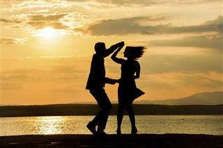 Couple dancing salsa at sunset