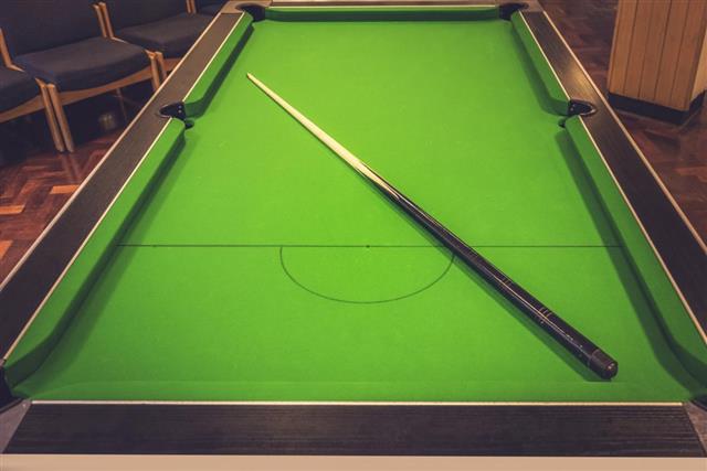 Pool table with cue stick