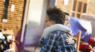 Young women forgiving each other with a hug