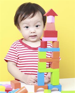 Cute Asian baby playing with blocks