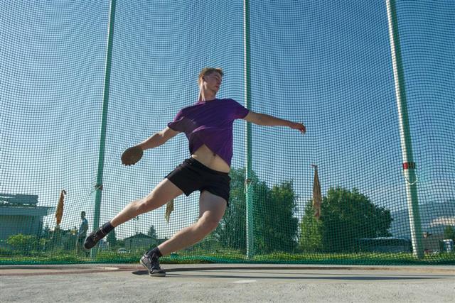 Young athlete throwing the discus